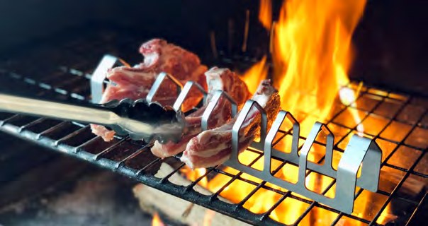 Stainless steel Dutchman Meat Rack holding chops over the flames